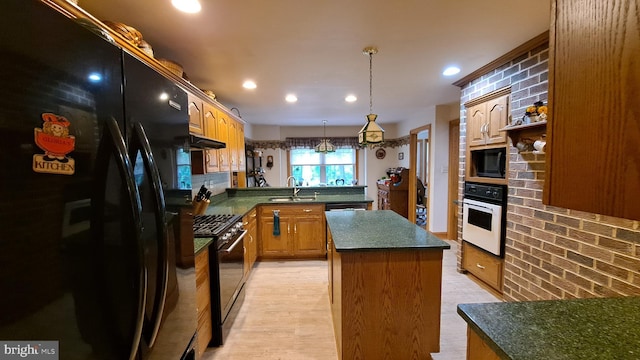 711 Tristan Trl, Chambersburg, PA 17202 - kitchen with black appliances, a peninsula, dark countertops, a sink, and a kitchen island