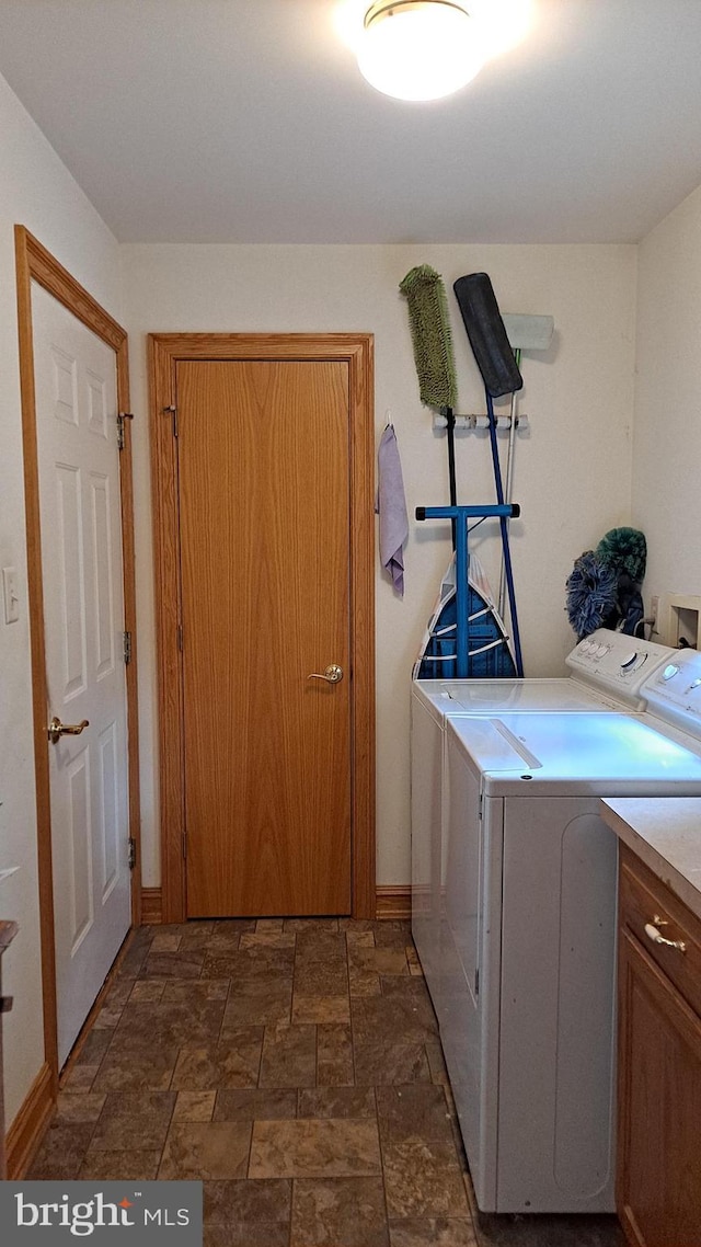 711 Tristan Trl, Chambersburg, PA 17202 - laundry room featuring separate washer and dryer, dark stone finish flooring, and baseboards