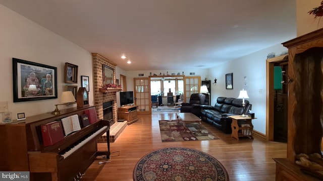 711 Tristan Trl, Chambersburg, PA 17202 - living area featuring light wood-style flooring, a brick fireplace, and recessed lighting