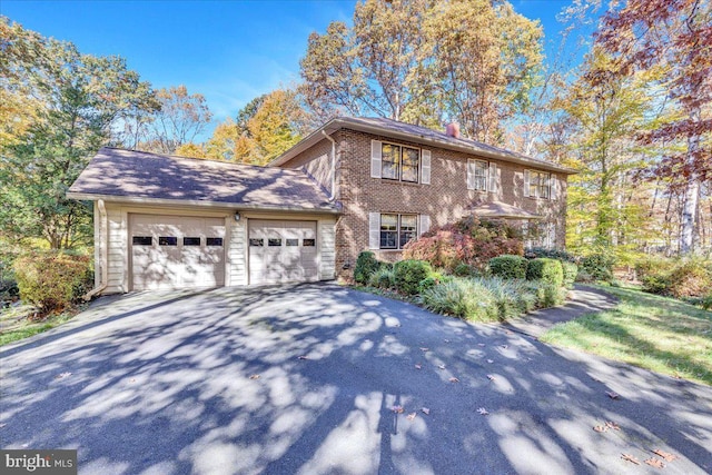 8150 Wolf Run Shoals Rd, Clifton, VA 20124 - view of front of home featuring driveway, a garage, brick siding, and a chimney