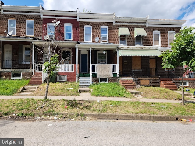 1522 Plum St, Baltimore City, MD 21226 - townhome / multi-family property with brick siding and a porch