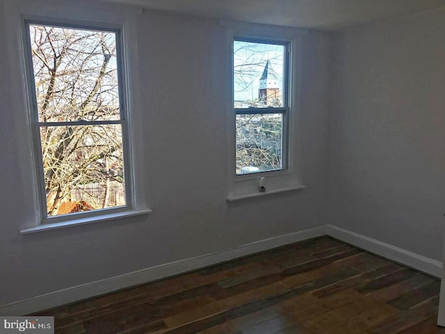 1522 Plum St, Baltimore City, MD 21226 - spare room featuring dark wood-style flooring, baseboards, and plenty of natural light