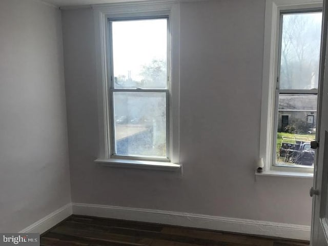 1522 Plum St, Baltimore City, MD 21226 - empty room with baseboards and dark wood-type flooring