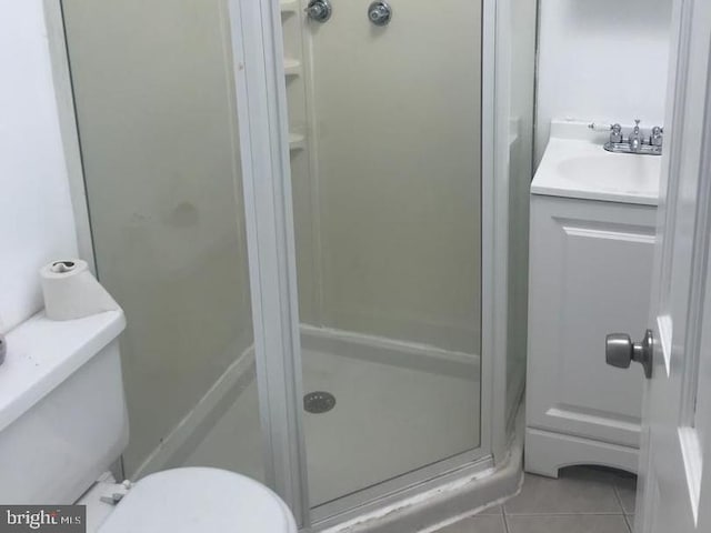 1522 Plum St, Baltimore City, MD 21226 - bathroom featuring a shower stall, toilet, tile patterned floors, and vanity