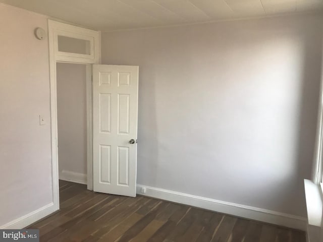 1522 Plum St, Baltimore City, MD 21226 - empty room with dark wood-style floors, baseboards, and a smoke detector