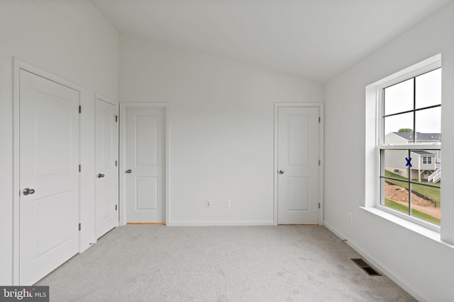 16 Angus Dr, Hanover, PA 17331 - unfurnished bedroom featuring vaulted ceiling, multiple windows, light colored carpet, two closets, and baseboards
