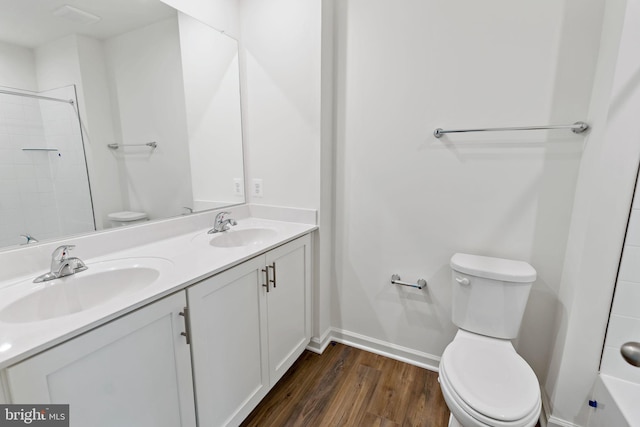16 Angus Dr, Hanover, PA 17331 - full bathroom with toilet, double vanity, wood finished floors, tiled shower, and baseboards