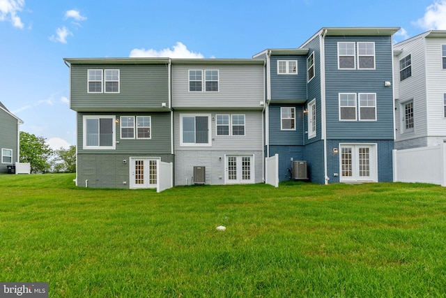 16 Angus Dr, Hanover, PA 17331 - rear view of house featuring french doors, cooling unit, a yard, and brick siding