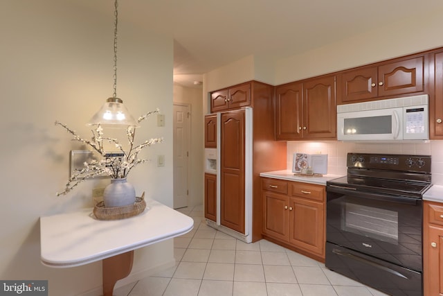 7 Brookside Cir, Myerstown, PA 17067 - kitchen with white microwave, black electric range oven, light countertops, brown cabinetry, and light tile patterned floors