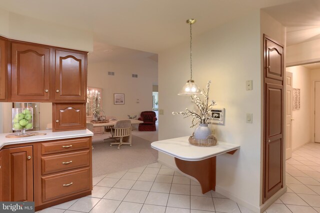 7 Brookside Cir, Myerstown, PA 17067 - kitchen featuring light tile patterned flooring, light countertops, light colored carpet, lofted ceiling, and brown cabinets
