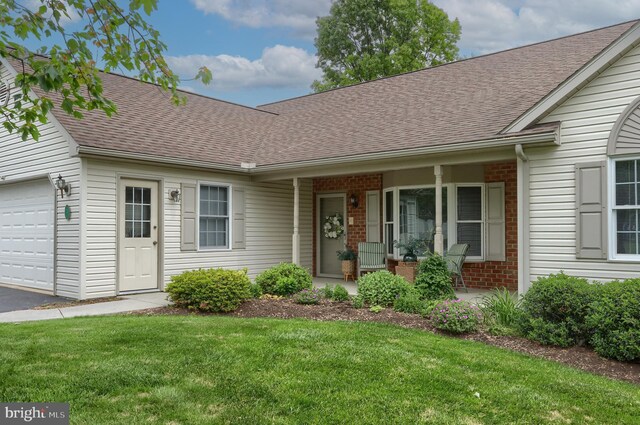 7 Brookside Cir, Myerstown, PA 17067 - view of front of home with brick siding, roof with shingles, a front yard, driveway, and an attached garage
