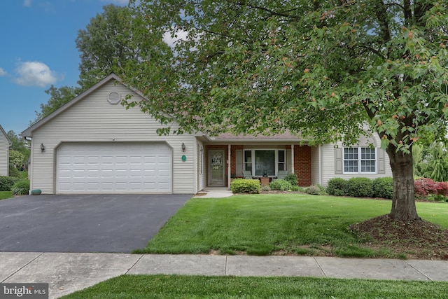 7 Brookside Cir, Myerstown, PA 17067 - view of front facade with driveway, a garage, a front yard, and brick siding