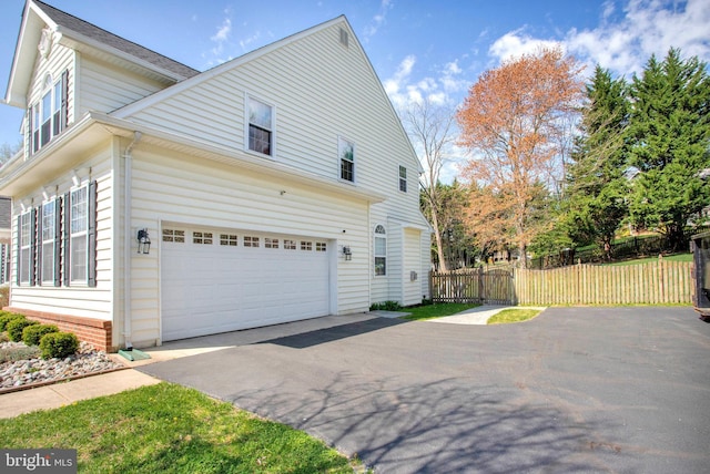 3270 Channel Ct, Huntingtown, MD 20639 - view of side of property featuring asphalt driveway and a garage