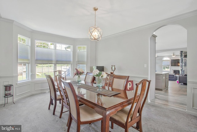 3270 Channel Ct, Huntingtown, MD 20639 - dining area with light colored carpet, crown molding, arched walkways, healthy amount of natural light, and a decorative wall