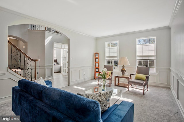 3270 Channel Ct, Huntingtown, MD 20639 - living area featuring arched walkways, a decorative wall, crown molding, light carpet, and a wainscoted wall