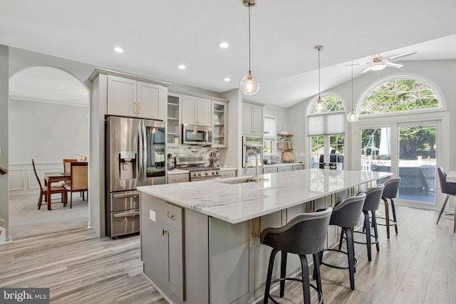 3270 Channel Ct, Huntingtown, MD 20639 - kitchen featuring stainless steel appliances, ceiling fan, a sink, a spacious island, and arched walkways