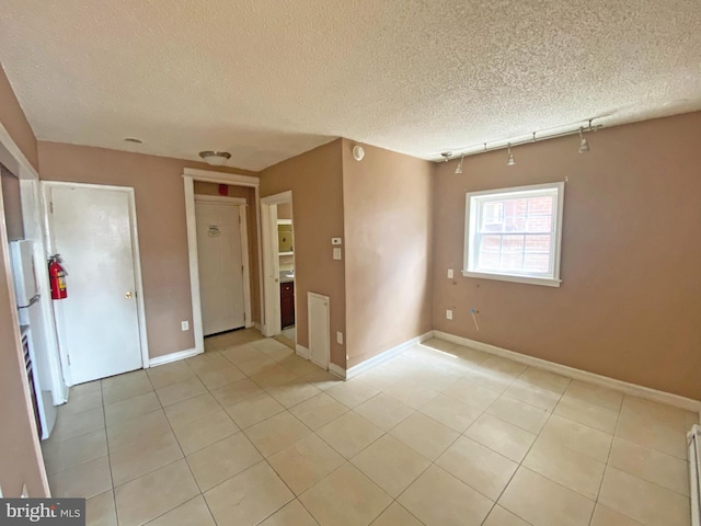 4621 N Broad St, Philadelphia, PA 19140 - spare room with light tile patterned floors, baseboards, and a textured ceiling