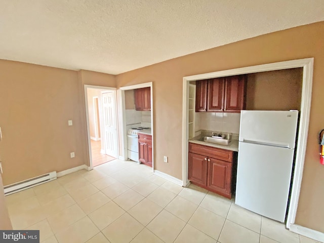 4621 N Broad St, Philadelphia, PA 19140 - kitchen featuring white appliances, a baseboard radiator, decorative backsplash, light countertops, and a textured ceiling