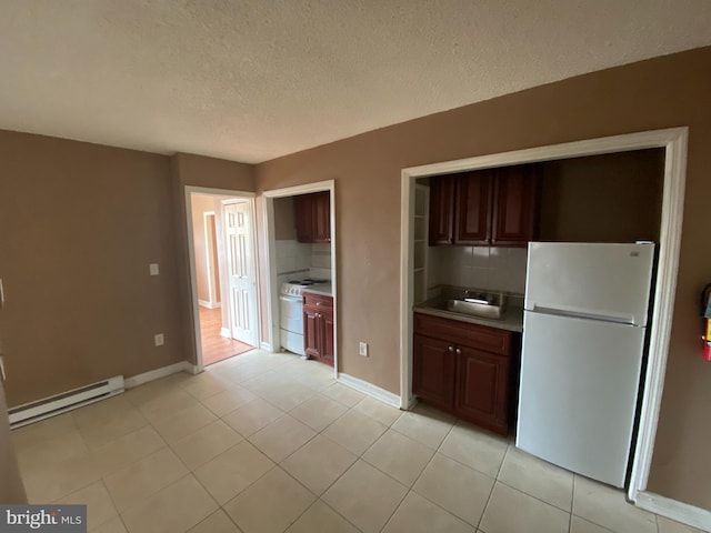 4621 N Broad St, Philadelphia, PA 19140 - kitchen with white appliances, baseboard heating, backsplash, a textured ceiling, and light countertops