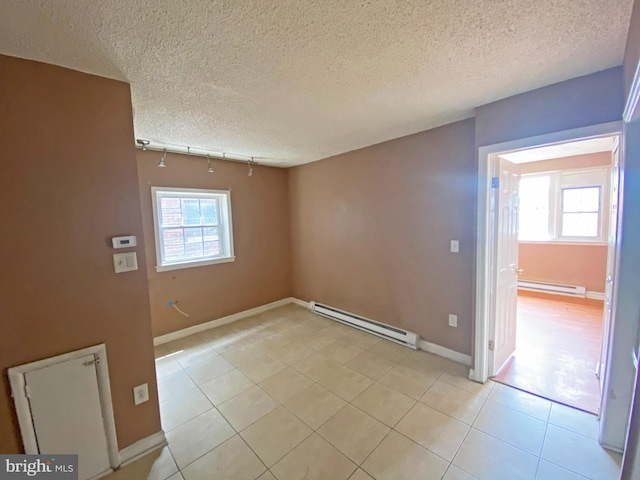 4621 N Broad St, Philadelphia, PA 19140 - unfurnished room featuring baseboard heating, light tile patterned floors, baseboards, a textured ceiling, and rail lighting