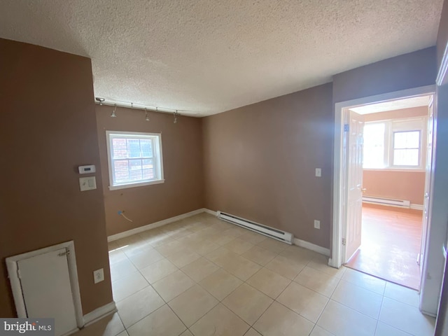 4621 N Broad St, Philadelphia, PA 19140 - unfurnished room with a baseboard radiator, plenty of natural light, light tile patterned flooring, and a textured ceiling