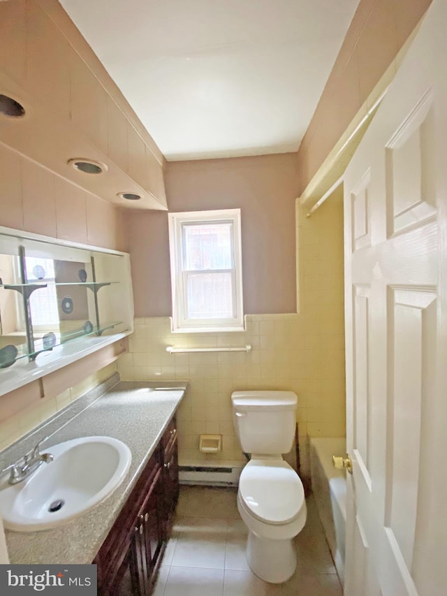 4621 N Broad St, Philadelphia, PA 19140 - full bath featuring tile walls, a baseboard radiator, vanity, toilet, and tile patterned flooring