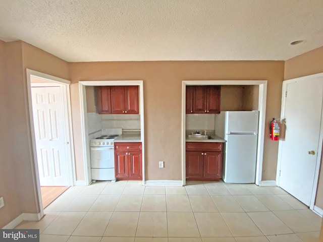 4621 N Broad St, Philadelphia, PA 19140 - kitchen with white appliances, a sink, light countertops, a textured ceiling, and baseboards