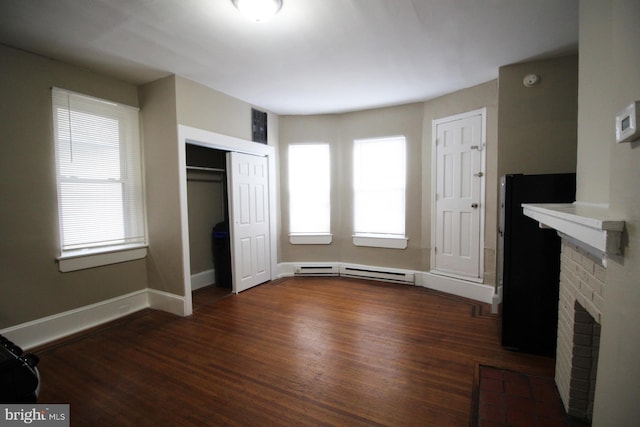 4621 N Broad St, Philadelphia, PA 19140 - unfurnished living room with a fireplace, baseboard heating, dark wood-type flooring, and baseboards