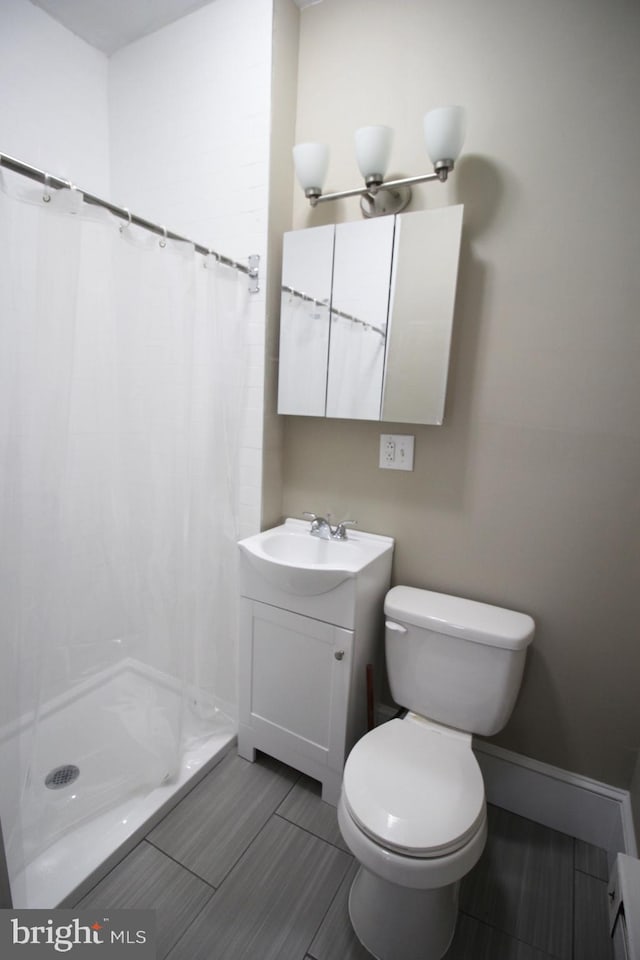4621 N Broad St, Philadelphia, PA 19140 - full bath with vanity, a stall shower, toilet, and wood finished floors