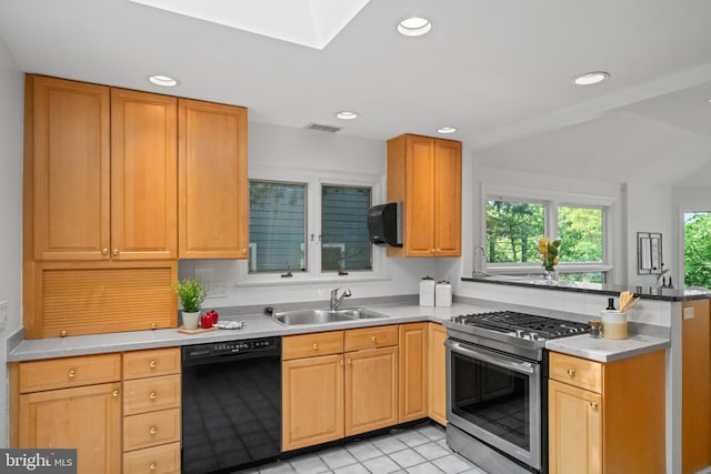 1414 N Johnson St, Arlington, VA 22201 - kitchen with black dishwasher, stainless steel range with gas cooktop, a sink, a peninsula, and light countertops