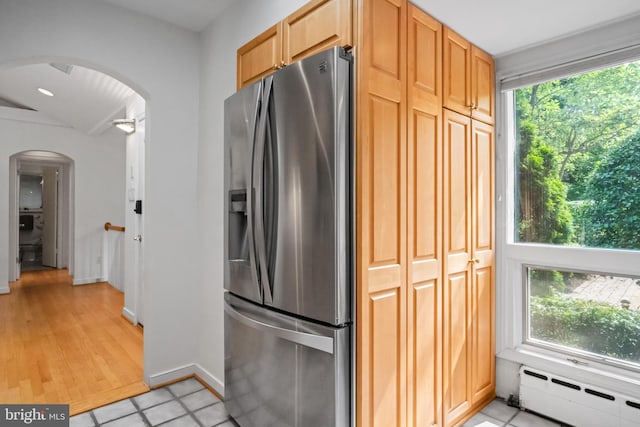 1414 N Johnson St, Arlington, VA 22201 - kitchen with stainless steel refrigerator with ice dispenser, a baseboard heating unit, arched walkways, light tile patterned flooring, and baseboards