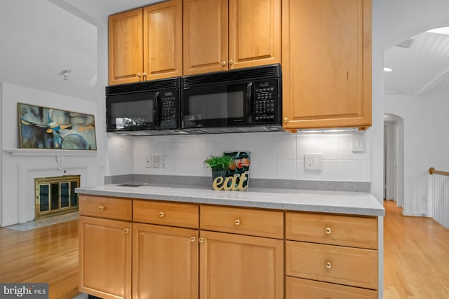 1414 N Johnson St, Arlington, VA 22201 - kitchen featuring black microwave, arched walkways, and light wood-style floors