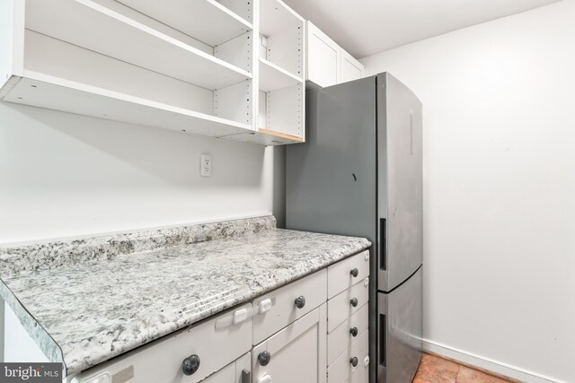 1414 N Johnson St, Arlington, VA 22201 - kitchen featuring freestanding refrigerator, white cabinets, open shelves, and baseboards