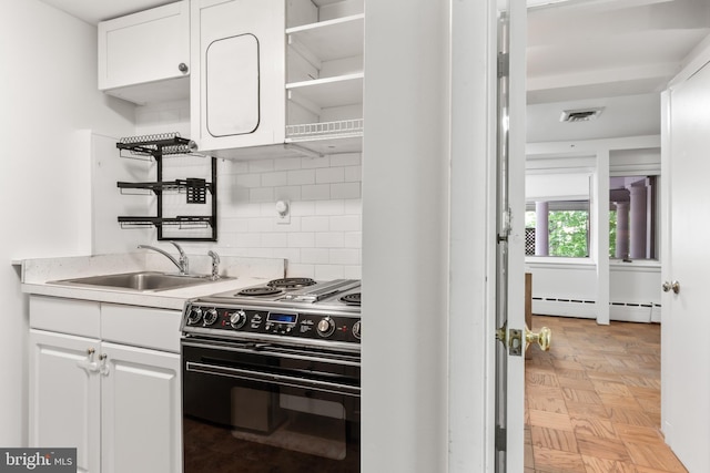 1414 N Johnson St, Arlington, VA 22201 - kitchen with electric stove, a sink, decorative backsplash, light countertops, and white cabinets