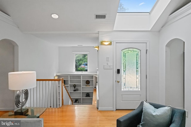 1414 N Johnson St, Arlington, VA 22201 - foyer entrance featuring wood finished floors, arched walkways, and a skylight