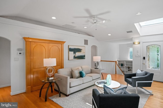 1414 N Johnson St, Arlington, VA 22201 - living area with vaulted ceiling, wood finished floors, arched walkways, a ceiling fan, and a skylight