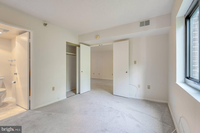 15115 Interlachen Dr Unit 3-920, Silver Spring, MD 20906 - unfurnished bedroom featuring light carpet, ensuite bathroom, a closet, and baseboards