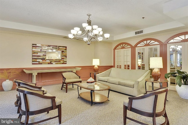 15115 Interlachen Dr Unit 3-920, Silver Spring, MD 20906 - living area with carpet, a chandelier, a tray ceiling, and a wainscoted wall