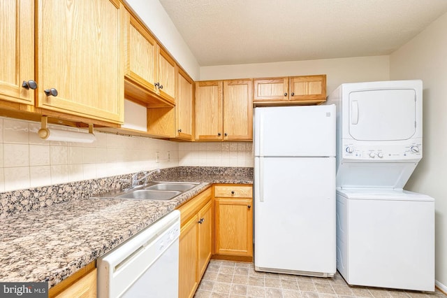 15115 Interlachen Dr Unit 3-920, Silver Spring, MD 20906 - kitchen with white appliances, estacked washer and dryer, a sink, backsplash, and light brown cabinetry