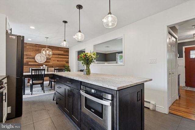 4811 Kings Rd, Doylestown, PA 18902 - kitchen with appliances with stainless steel finishes, wooden walls, dark cabinetry, pendant lighting, and a kitchen island