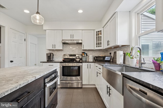 4811 Kings Rd, Doylestown, PA 18902 - kitchen with stainless steel appliances, under cabinet range hood, white cabinetry, a sink, and recessed lighting