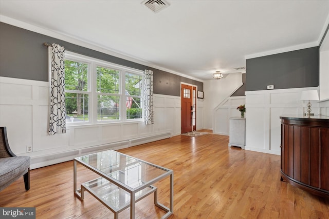 4811 Kings Rd, Doylestown, PA 18902 - unfurnished living room featuring a decorative wall, wainscoting, light wood finished floors, and crown molding