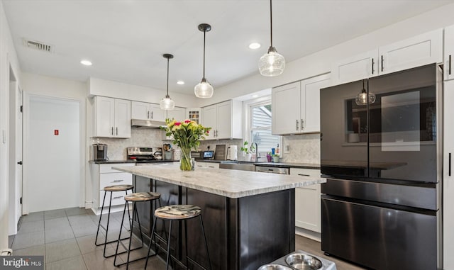 4811 Kings Rd, Doylestown, PA 18902 - kitchen featuring under cabinet range hood, appliances with stainless steel finishes, white cabinets, backsplash, and recessed lighting