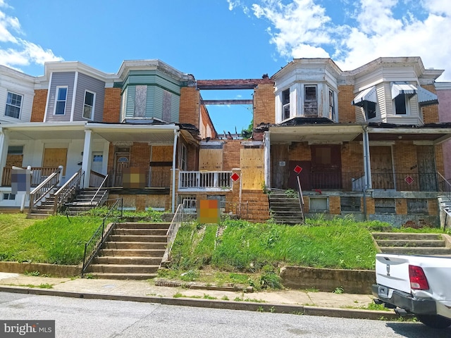 720 E 23rd St, Baltimore, MD 21218 - multi unit property featuring a porch, stairway, and brick siding