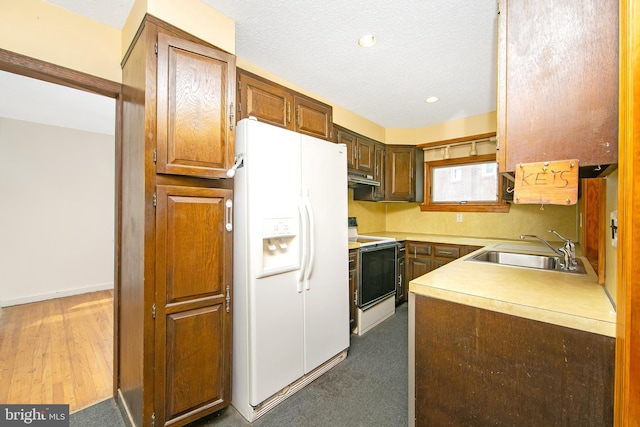 681 Dutton Cir, Springfield, PA 19064 - kitchen with white appliances, a sink, under cabinet range hood, a textured ceiling, and light countertops