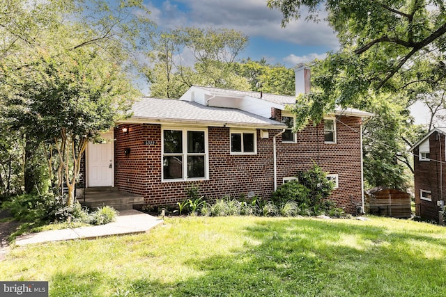 6322 Phyllis Ln, Alexandria, VA 22312 - view of front of home featuring a chimney, brick siding, a front lawn, and a shingled roof