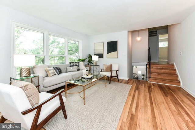 6322 Phyllis Ln, Alexandria, VA 22312 - living room featuring healthy amount of natural light, light wood-style flooring, and baseboards