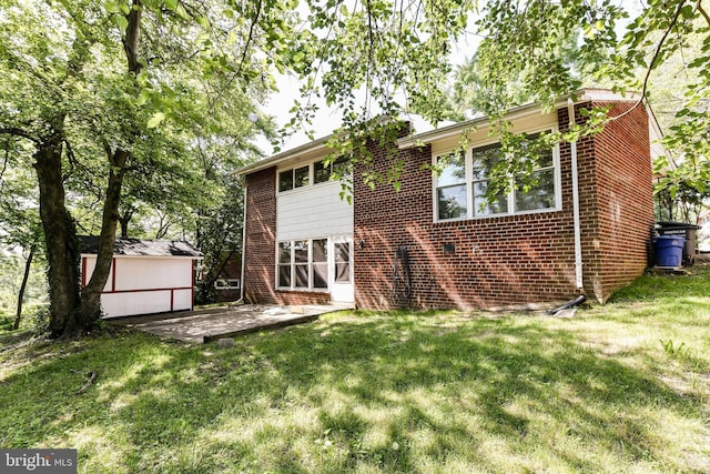 6322 Phyllis Ln, Alexandria, VA 22312 - view of front of home with brick siding, a front yard, and a patio
