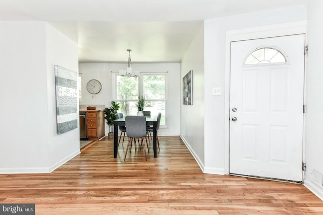 6322 Phyllis Ln, Alexandria, VA 22312 - dining room featuring a chandelier, light wood finished floors, and baseboards