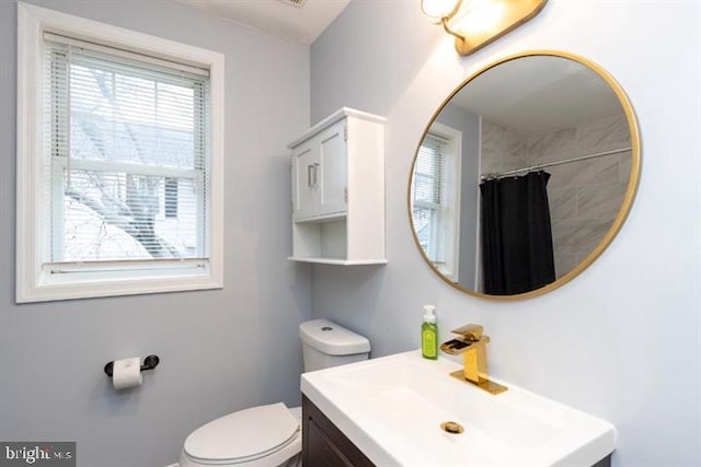 2306 Monticello Rd, Baltimore, MD 21216 - bathroom with vanity, healthy amount of natural light, toilet, and a shower with shower curtain